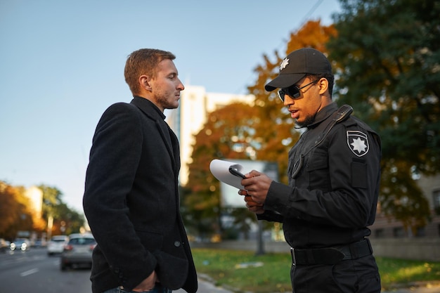 A security officer escorting a student on a college campus at night, highlighting the safety and security provided by the escort program.