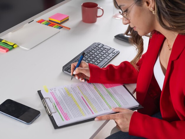 A student meticulously reviewing their resume, highlighting key skills and experiences with a marker.