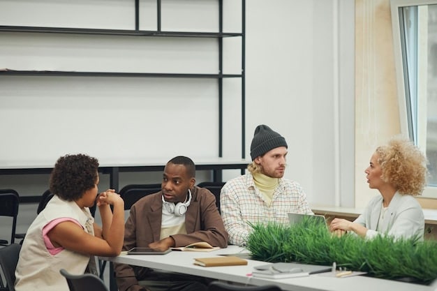 A diverse group of students participating in a collaborative project in a modern, well-lit classroom. The focus is on teamwork and problem-solving, with students actively discussing ideas and using laptops for research. The image conveys an atmosphere of engagement and practical application of knowledge, reflecting the importance of soft skills in education.
