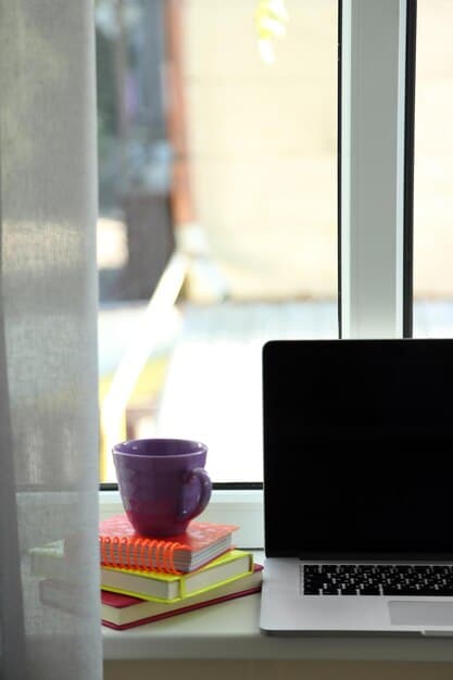 A well-organized desk with laptop, books, and stationery, bathed in natural light from a nearby window. The scene evokes focus, productivity, and a calm learning atmosphere