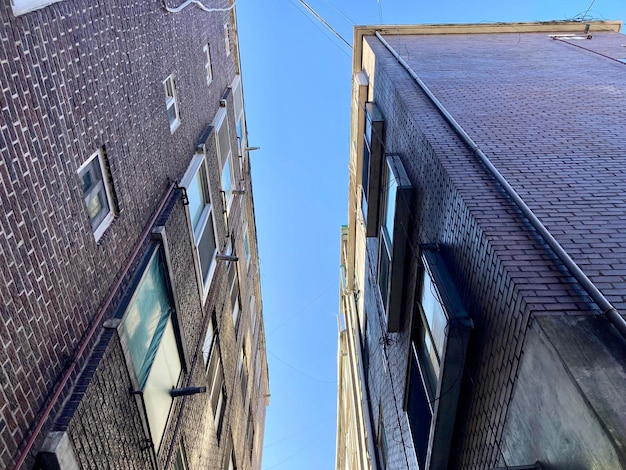 A split image showing a single-family home on one side and a multi-unit apartment building on the other side, representing different types of real estate investments.