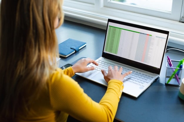 A person using a laptop to review student loan repayment options, with graphs and charts displayed on the screen.