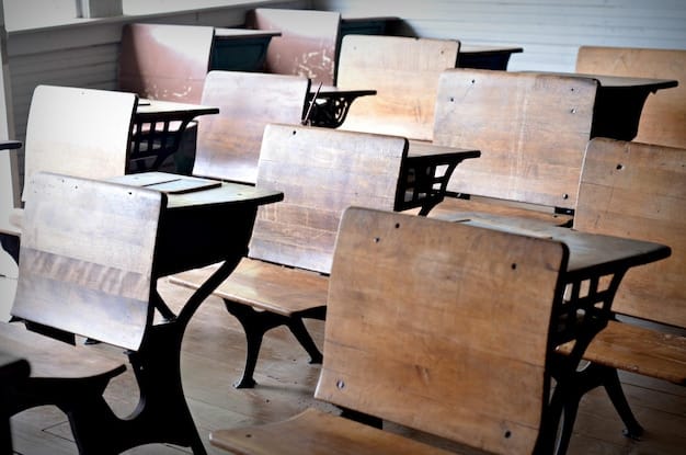 A photograph of a high school classroom, with desks closely packed together and students struggling to focus. The teacher looks overwhelmed and tries to manage the large class.