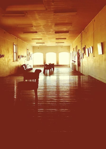 A split image contrasting a traditional public school classroom with rows of desks and a teacher at the front, versus a modern charter school classroom with flexible seating, collaborative projects, and technology integration. This illustrates the difference in learning environments under different school choice models.