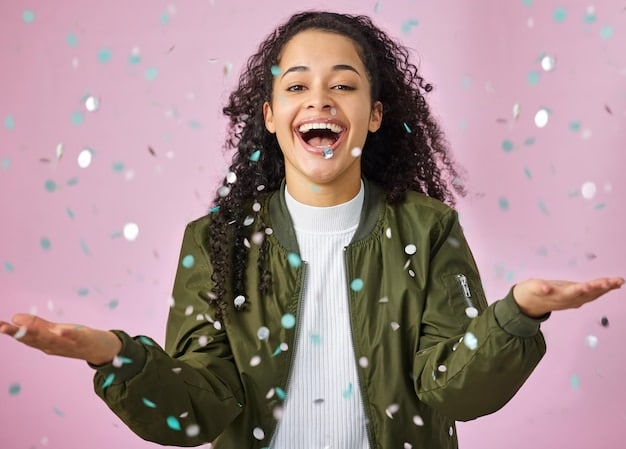 A student happily celebrating, surrounded by confetti, holding up a paper with 