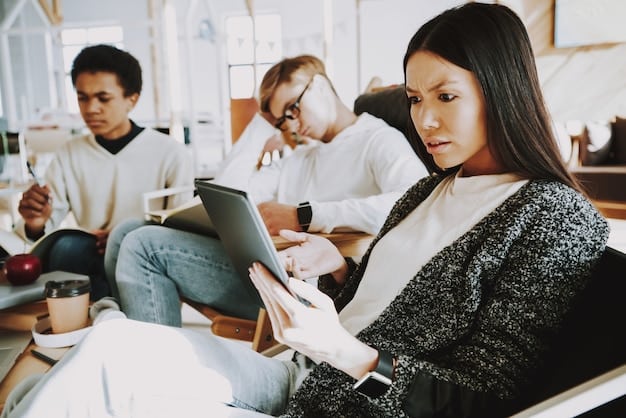 A diverse group of college students collaborating on a project in a modern classroom, using tablets and laptops, with a professor assisting in the background.