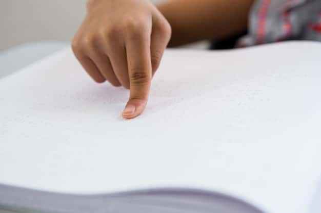 A close-up shot of a professor's hand writing a letter grade on a student's assignment. The background is blurred, focusing on the grade itself (e.g., A-, B+).