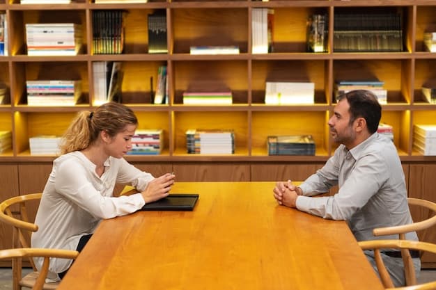 Two students in a library setting. One is practicing interview questions with the other, simulating a real interview scenario.