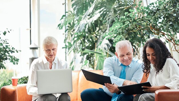 An inspiring image showing diverse professionals confidently managing their retirement portfolios on laptops and tablets, set against a backdrop of modern office spaces and city skylines, emphasizing the accessibility and importance of retirement planning.