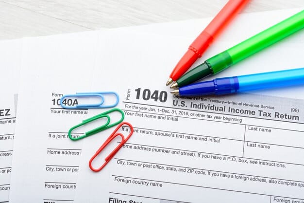 A close-up shot of a tax form highlighting the section for dependents, with a pen pointing to the age requirement for the child tax credit.