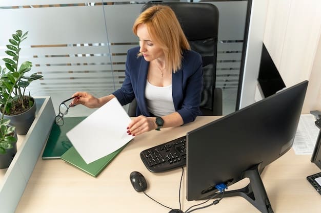 A person sitting at a desk, filling out an application form with a laptop nearby. The person is focused and appears determined, symbolizing the effort required to apply for rental assistance programs.
