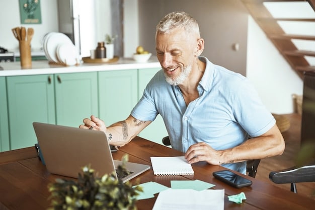 A person reviewing their retirement plan options on a laptop, with a satisfied smile. The background shows a comfortable home office setting, suggesting financial planning and security.