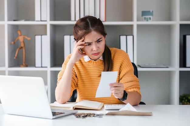 A person looking stressed while reviewing student loan bills. The image evokes the emotional burden of student debt.